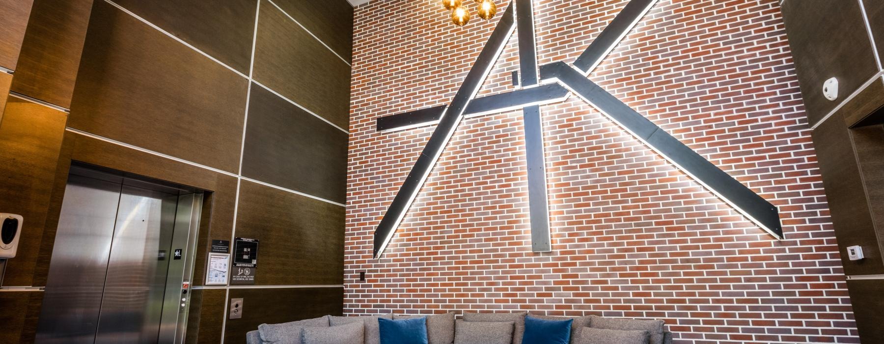 a couch and a table in a room with a brick wall
