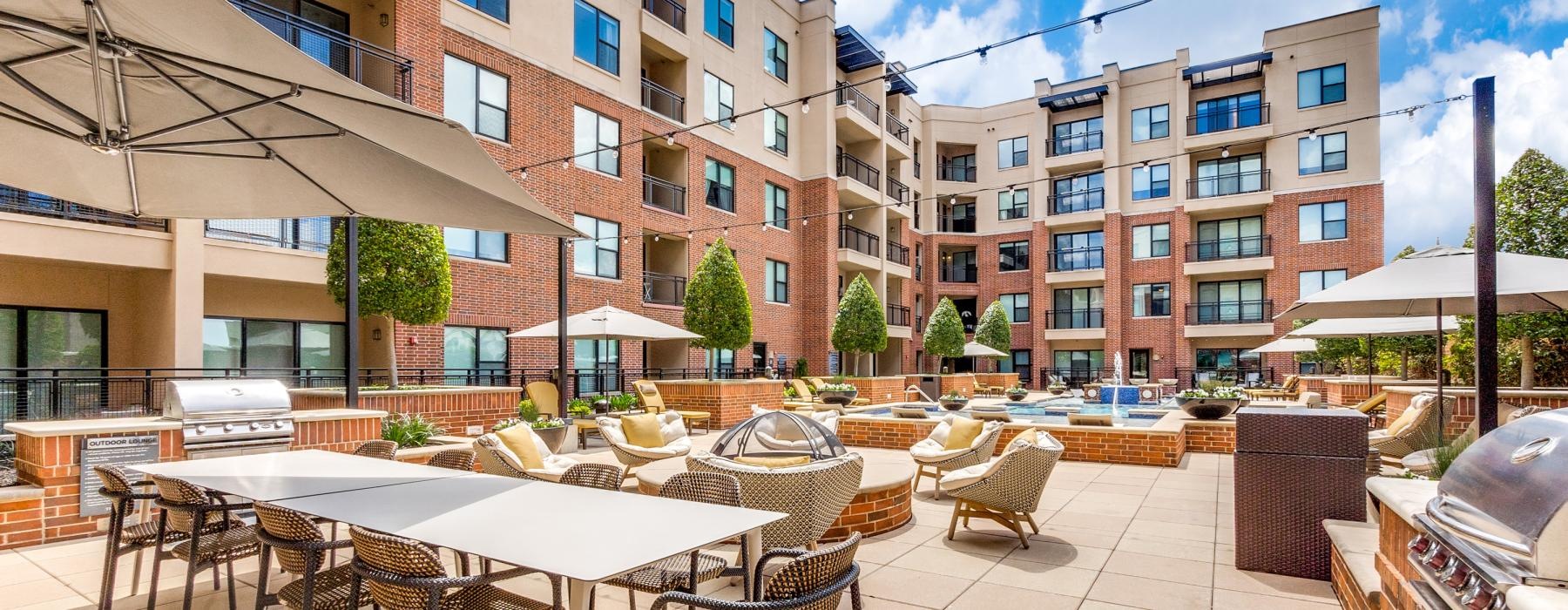 a patio with tables and chairs outside