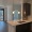 an empty kitchen and living room with wood cabinets and floors