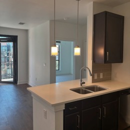 A2 floorplan still on the market! an empty kitchen and living room with wood cabinets and floors