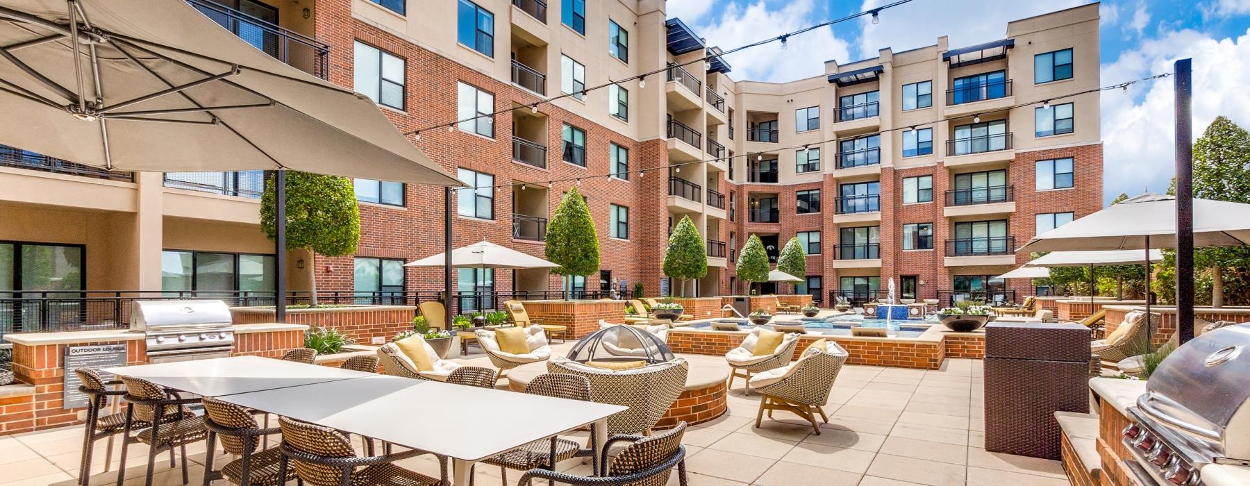 a patio with tables and chairs outside