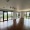 an empty living room with wood floors and many windows