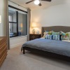 a bedroom with a bed and lamps