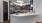 a kitchen with black cabinets and a white counter island