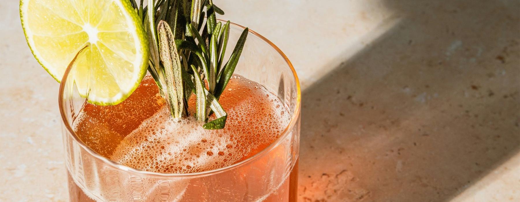 a glass with a drink and a lemon on top