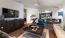 a living room with a large tv and a couch