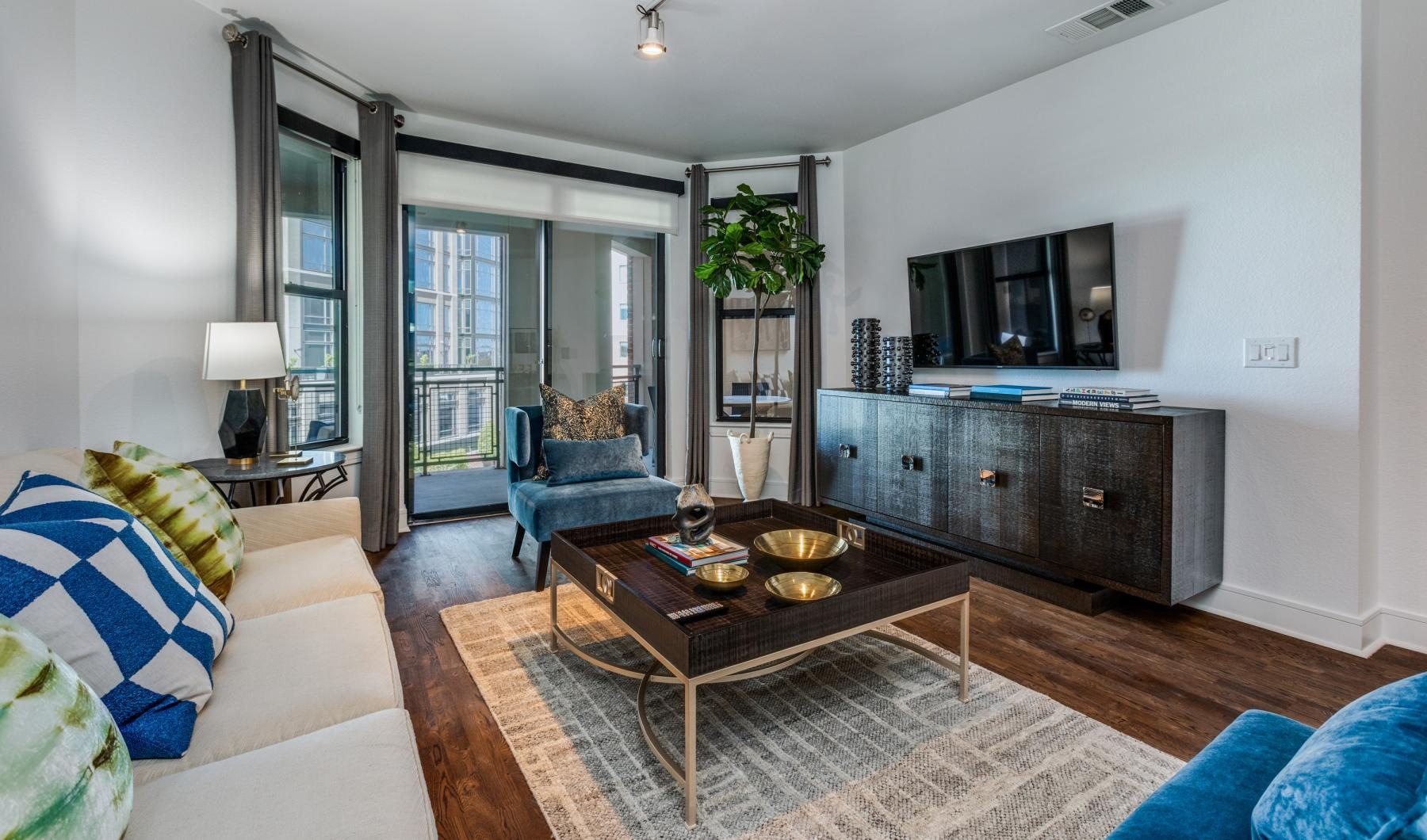 a living room with a couch and a table and windows
