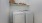 a white room with a shelf and a washer and dryer