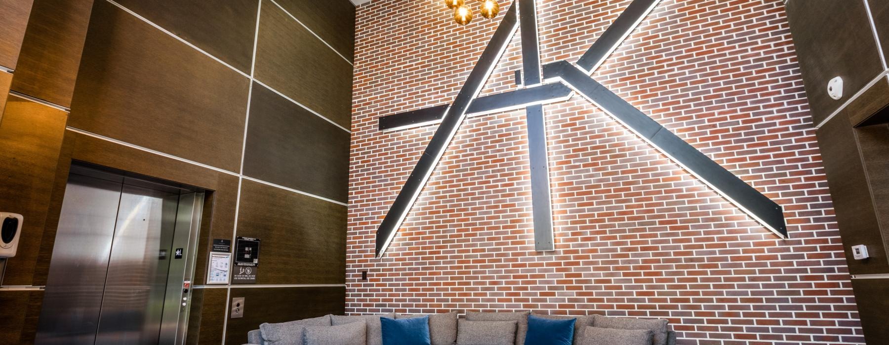 a couch and a table in a room with a brick wall