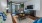 a living room with a couch and a table and windows
