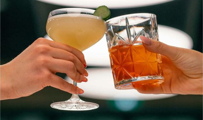 Vibrant community life with a variety of dining options hands holding glasses with cocktails